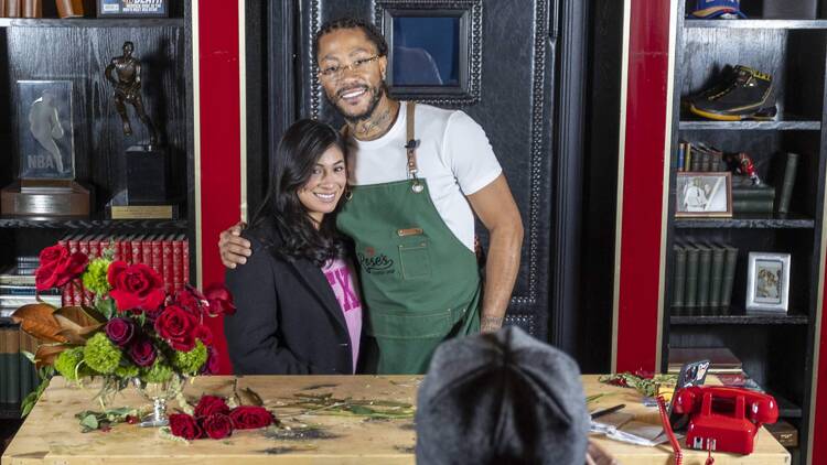 Derrick Rose takes a photo with a fan