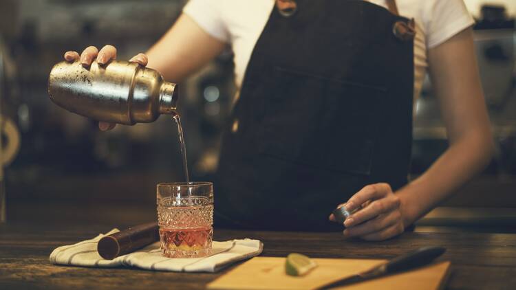 A woman pours a drink she made.