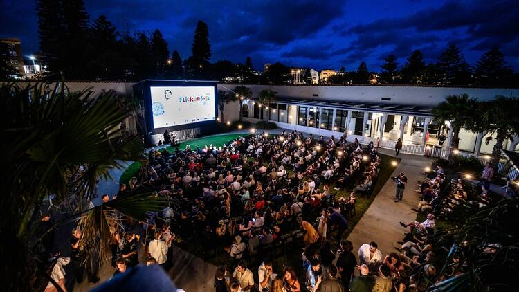 a crowd watching an outdoor film