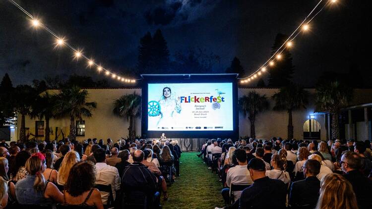 a crowd watching an outdoor film