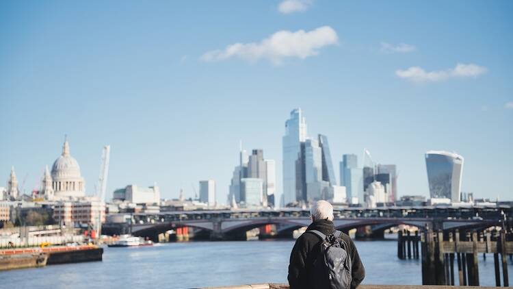 Elderly man with grey hair and the London skyline