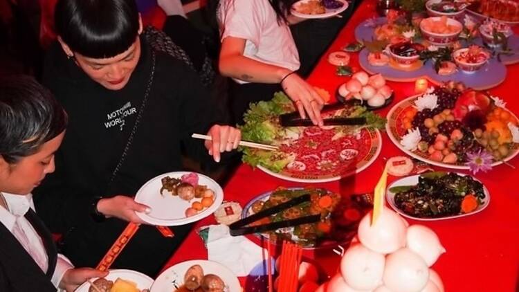 people eating from a large table people eating from a large table
