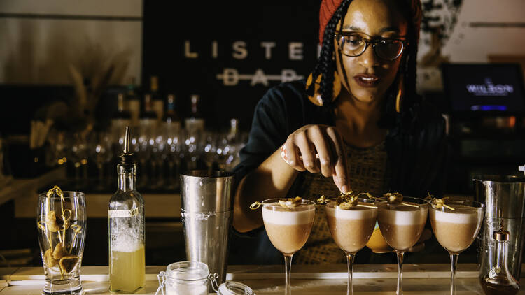 A bartender garnishing cocktails