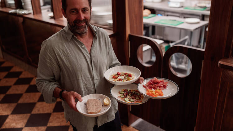 Owner James Lancaster carrying food