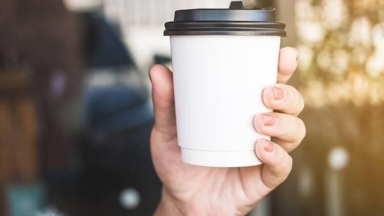 Takeaway coffee cup held in a hand