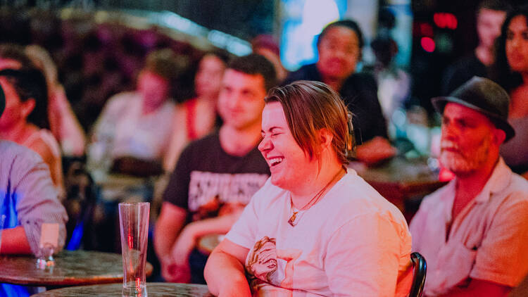 People laugh during a comedy show.