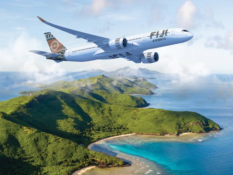 Fiji airways plane flying over island