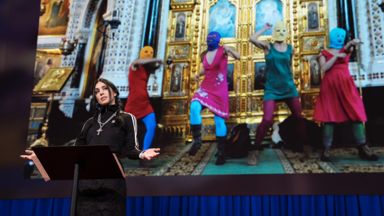 Nadya Tolokonnikova gives a talk in front of a projected photo of her band Pussy Riot.