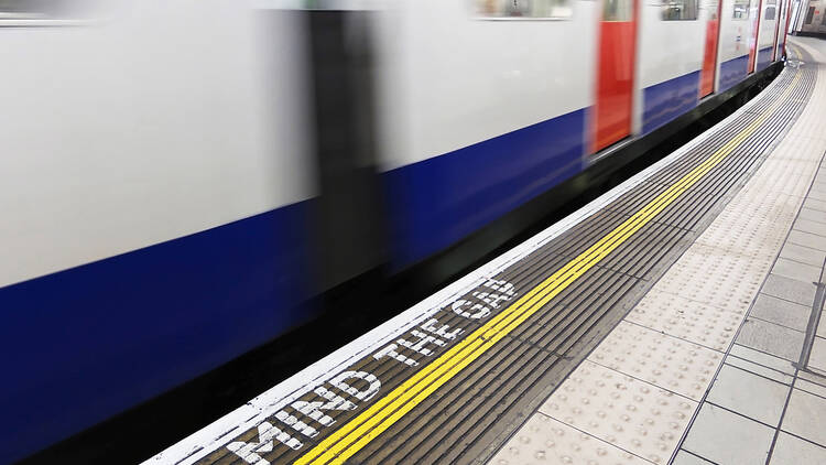 Tube train with ‘Mind the Gap’ sign