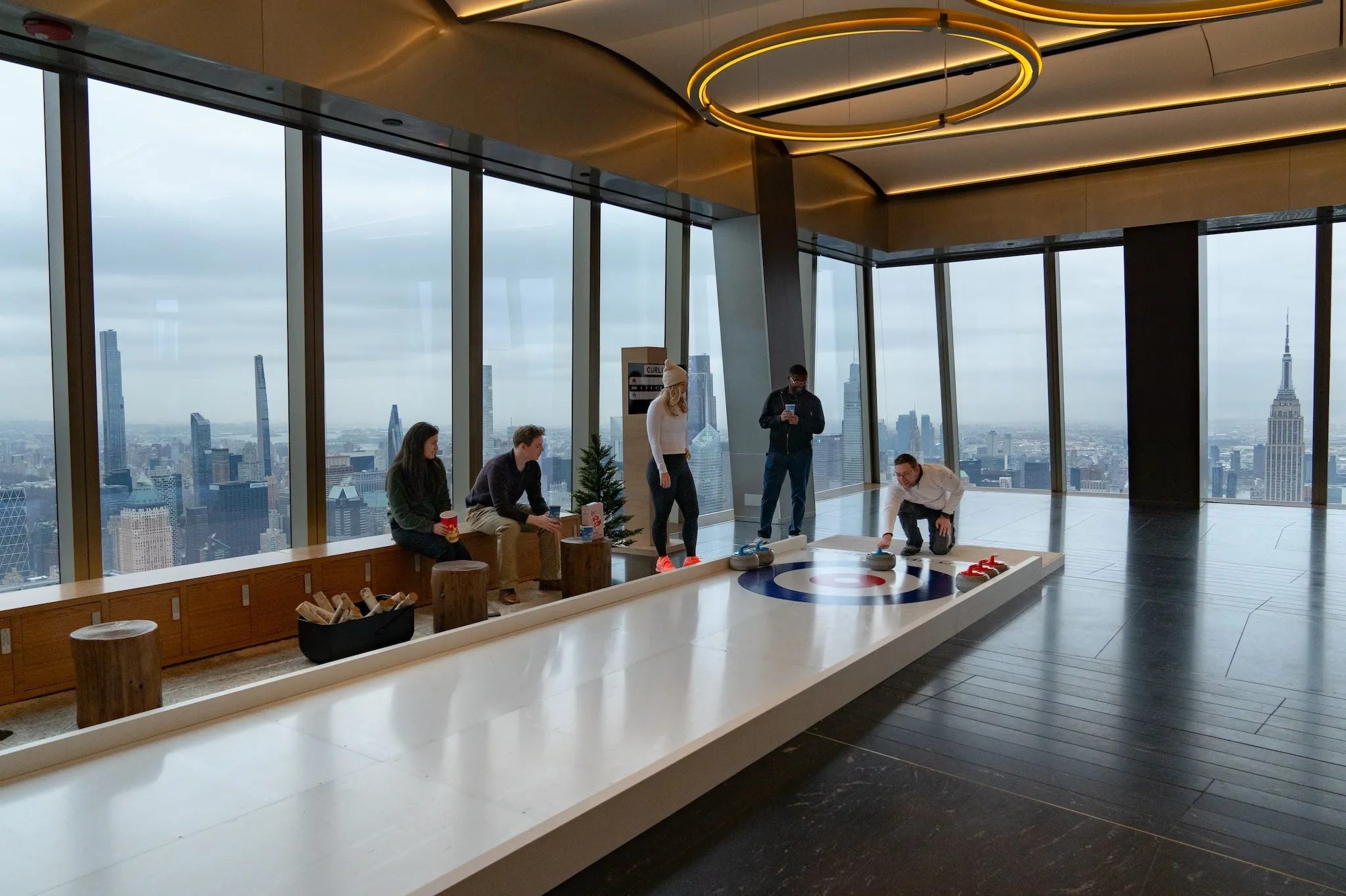 A group of people play a game of curling at Edge.