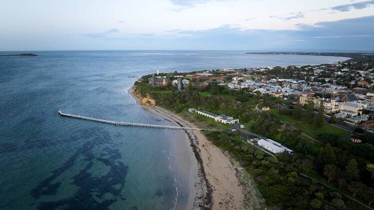 Aerial view of seaside town with long jetty