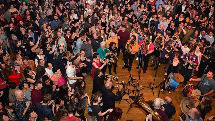 A crowd of people dances at a festival.