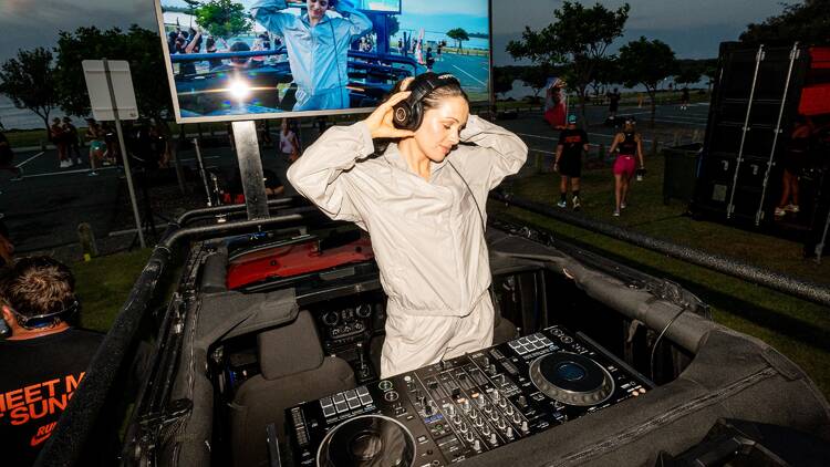 DJ performing in trunk of car