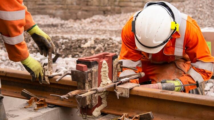 Railway workers in the UK working on train tracks