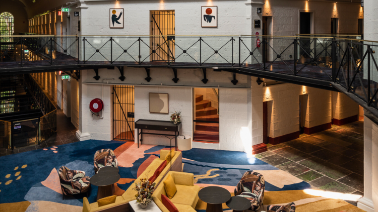 The atrium of Pentridge decorated with a colourful rug, couches and small tables