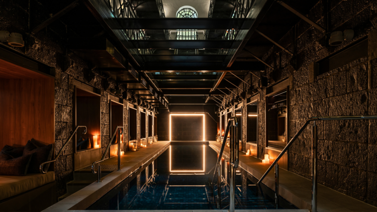 A candlelit underground relaxation pool