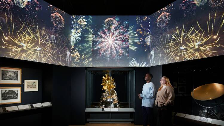 Two visitors looking at exhibits in the Science Museum’s Versailles: Science and Splendour’ exhibition