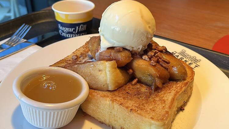 A plate of french toast with an ice cream scoop