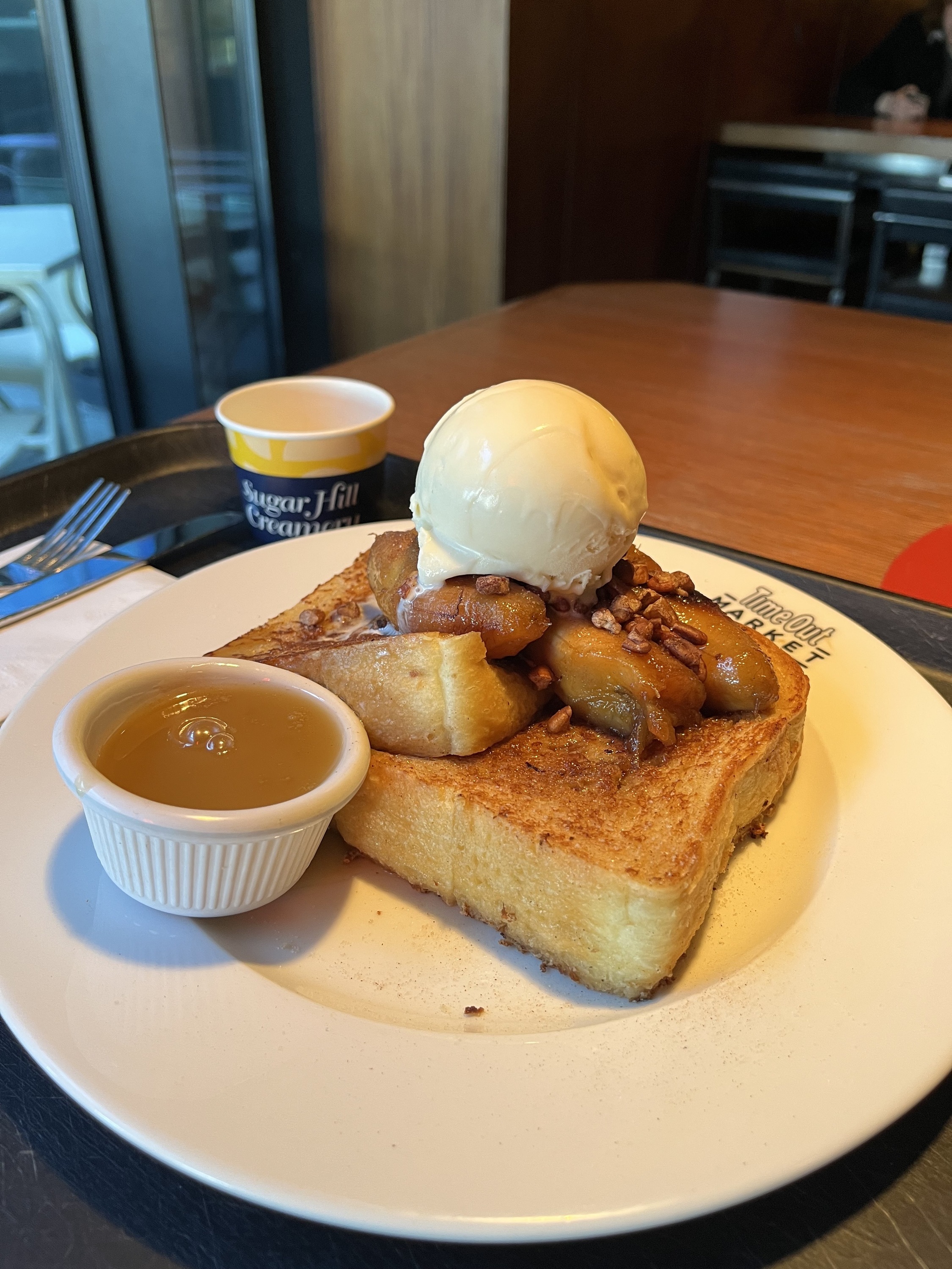 A plate of french toast with an ice cream scoop