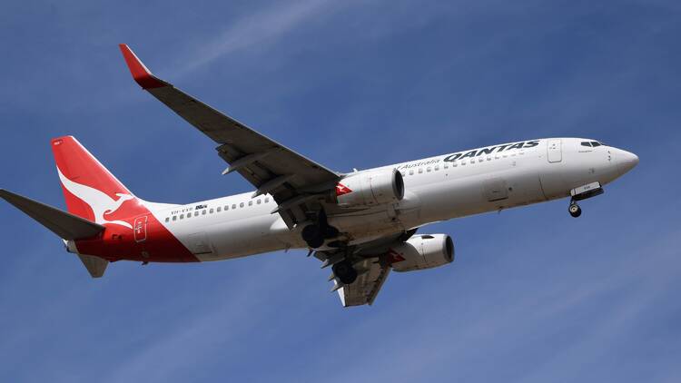 Qantas plane flying in blue sky