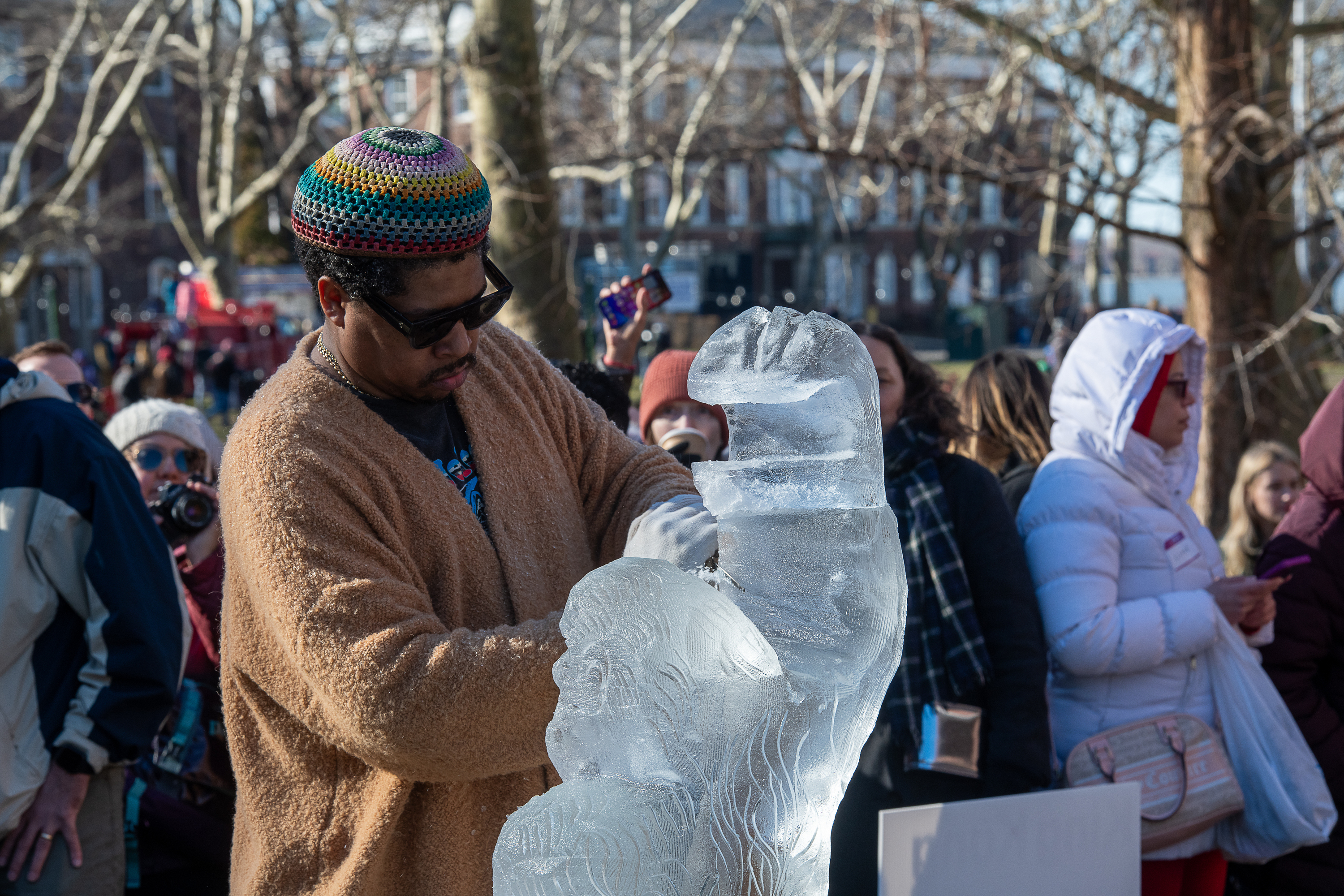 A man carves details into a block of ice.