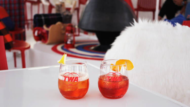 Drinks in TWA Hotel-branded glasses.