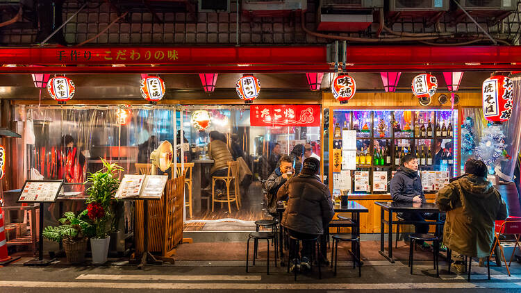 People dining outside a restaurant in Osaka, Japan