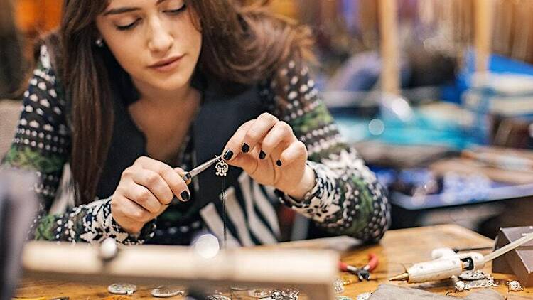 A woman making a necklace