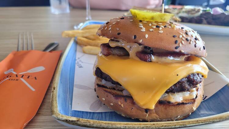 A hamburger on a blue plate