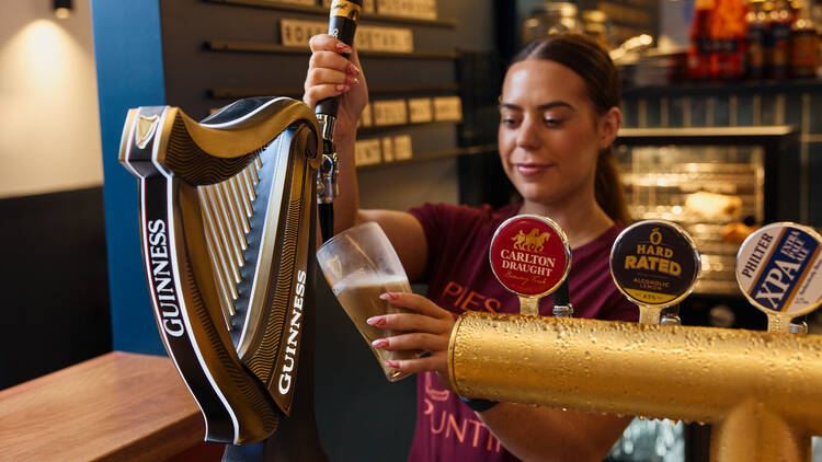 A woman pouring a beer