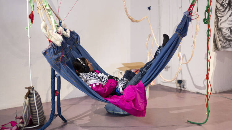 Woman on a hammock at W139 art exhibit