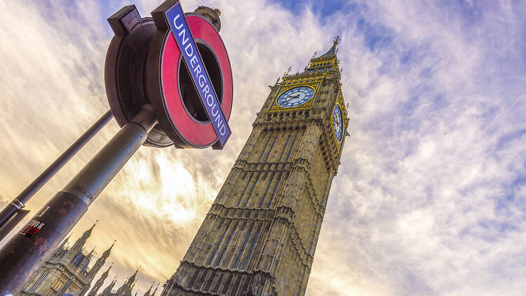 London Underground sign next to Big Ben and the Houses of Parliament