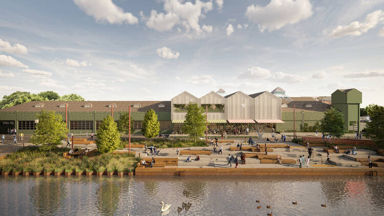 Rendered image of the Canada Water regeneration project, water with ducks in foreground, people sitting along the waterfront and newly renovated industrial building behind. 