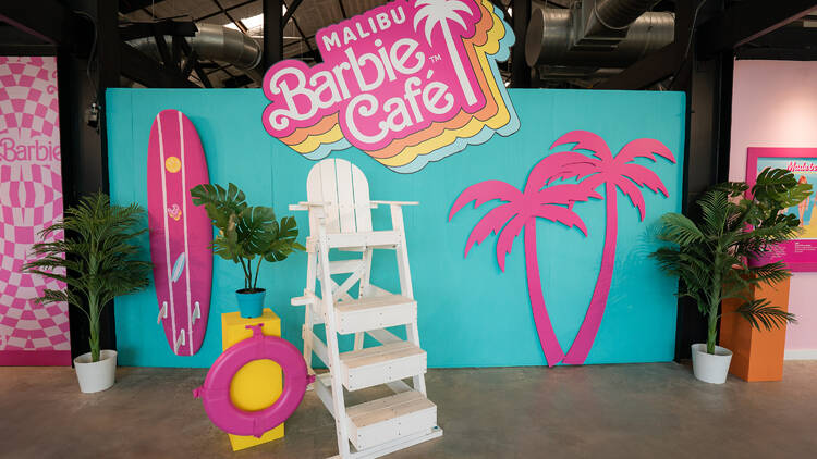 Lifeguard chair in front of Malibu Barbie Cafe backdrop 