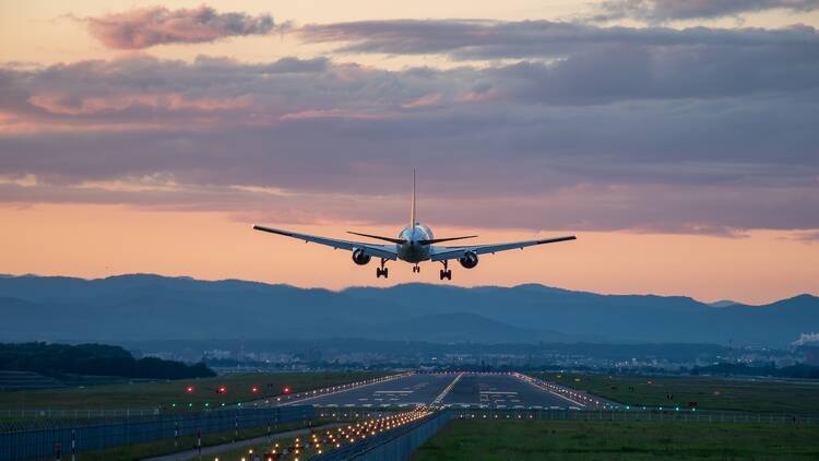 Jet plane landing at an airport at dusk