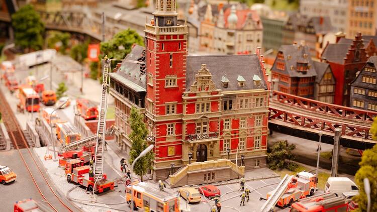 Miniatur Wunderland Hamburg in Germany, 12.12.2023, fire brigade department extinguishes fire, burning house, museum with miniature model construction of the world