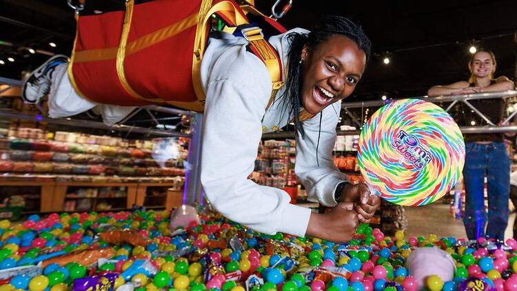 Human in candy claw holding lolly pop