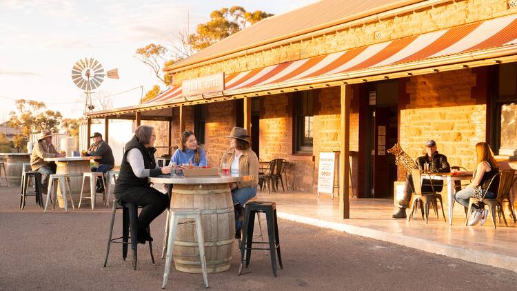 People drinking outside at outback pub