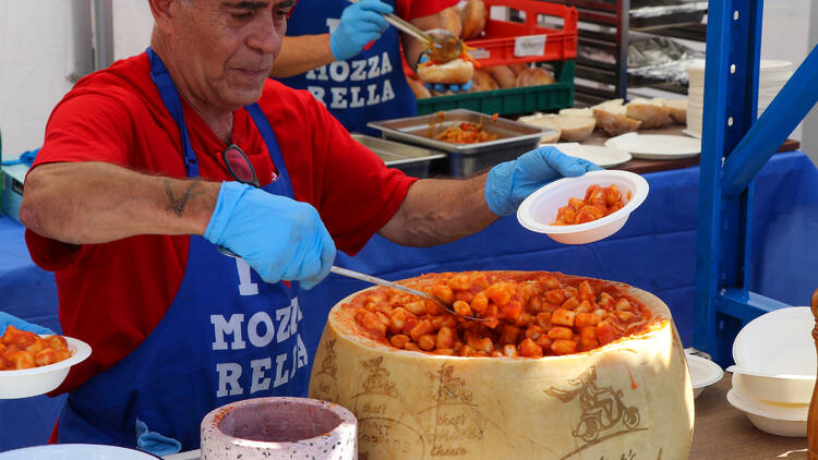 A man serving up gnocchi.