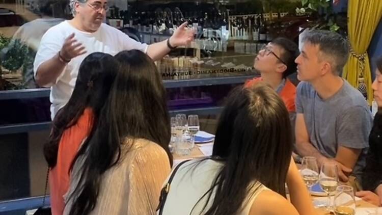 man speaking to people seated at table