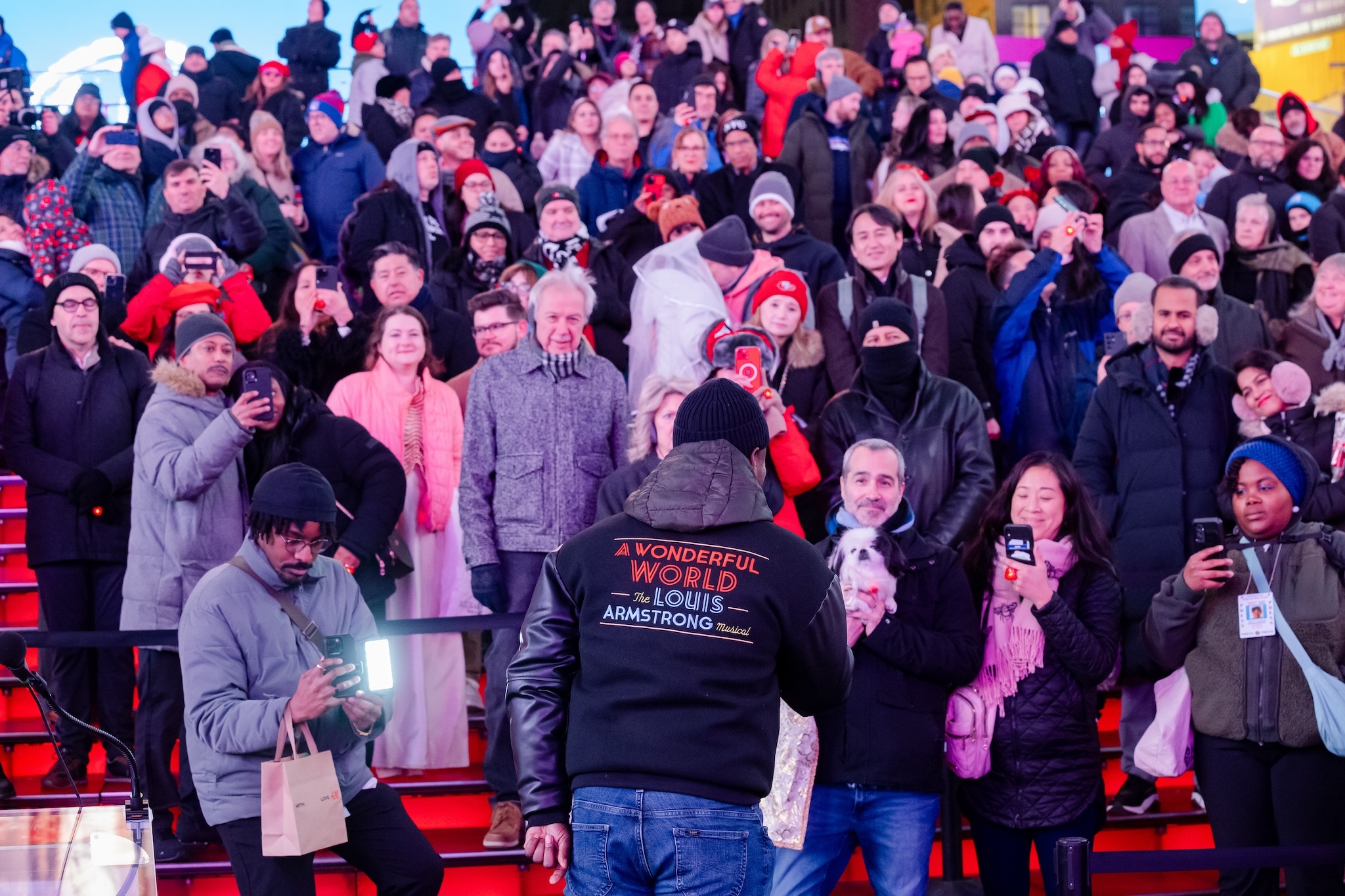 A Broadway performer sings a Louis Armstrong song in Times Square.