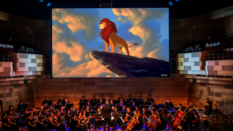 Orchestra plays while Lion King is on screen