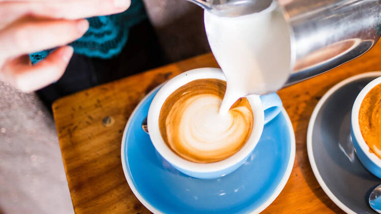 barista pouring coffee