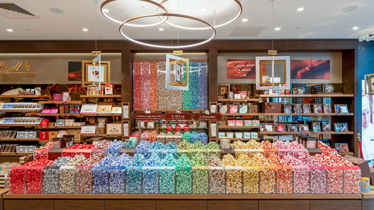 Big selection of multicoloured chocolate truffles inside a Lindt store