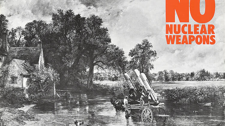 A poster with a black-and-white farm-like background and orange text reading "NO NUCLEAR WEAPONS."