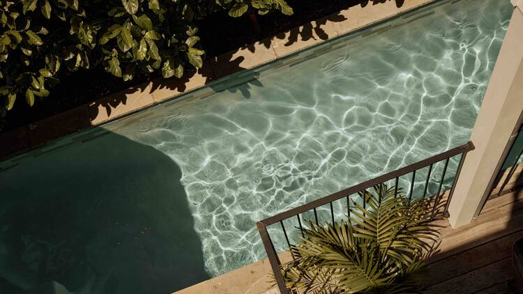 An pool with clear water sparkling on a sunny day. 