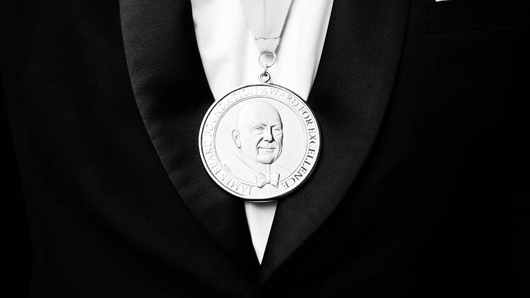 Person wearing a suit and James Beard Award medal