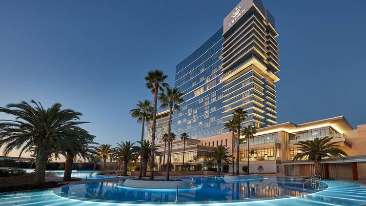 Exterior of Crown Towers Perth with pool at night