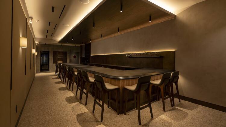A wooden counter with white walls