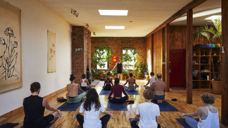 People practice in a yoga class.